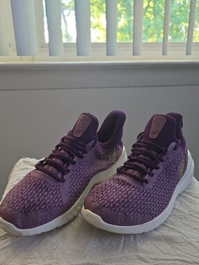 Women's Nike Renew Rival running shoes in a purple colorway.